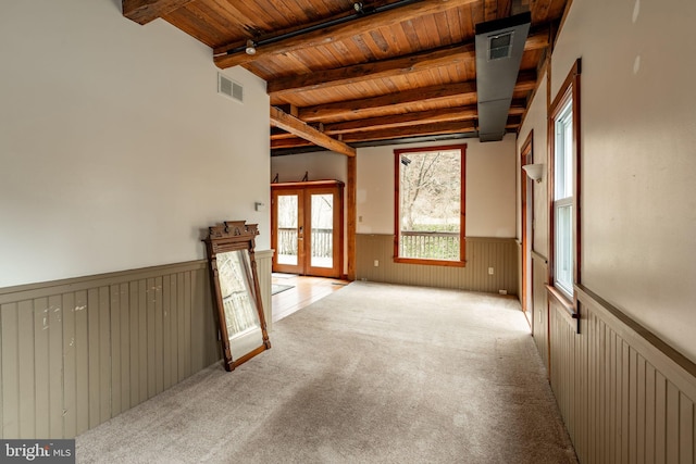 unfurnished room featuring a wainscoted wall, wood ceiling, visible vents, french doors, and beamed ceiling