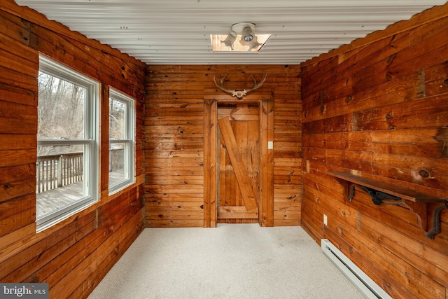 carpeted empty room with a baseboard radiator