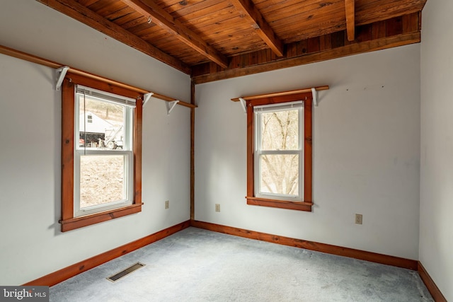 unfurnished room with baseboards, visible vents, wooden ceiling, beamed ceiling, and carpet