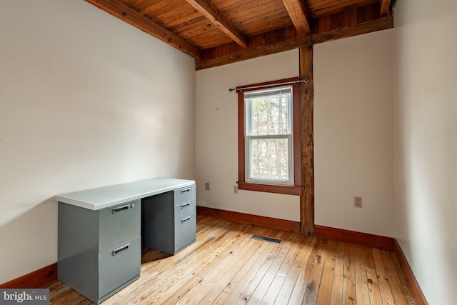 unfurnished office featuring wooden ceiling, light wood-style flooring, visible vents, baseboards, and beamed ceiling