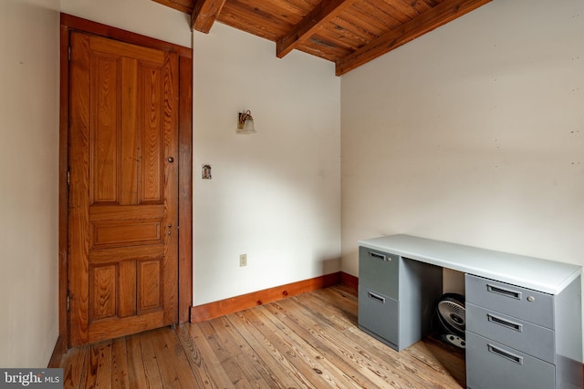 unfurnished office featuring wood ceiling, baseboards, beamed ceiling, and light wood finished floors