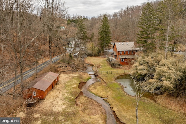 drone / aerial view featuring a view of trees