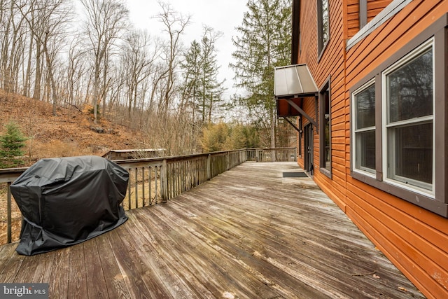 wooden deck featuring area for grilling