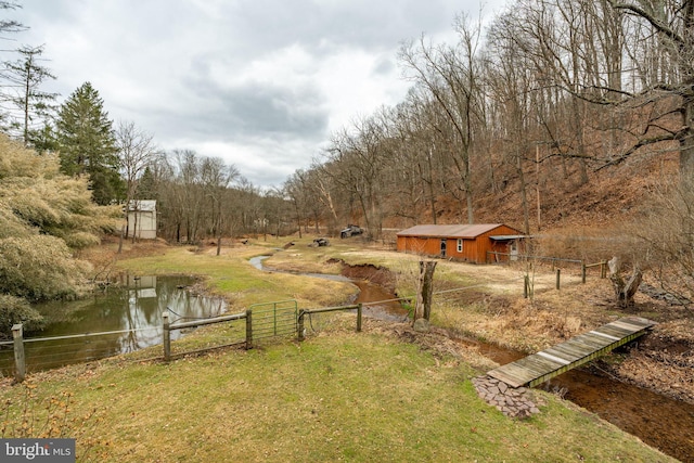 view of yard featuring fence and a view of trees