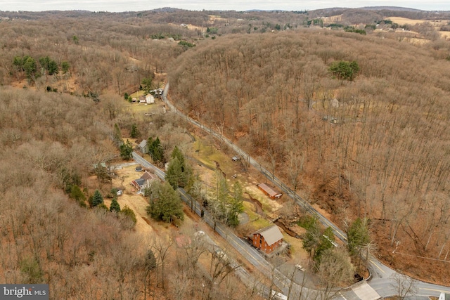 drone / aerial view featuring a forest view