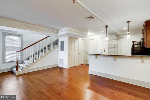 interior space featuring visible vents, stairway, and wood finished floors