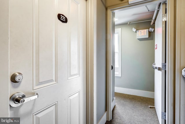 hallway with carpet and baseboards