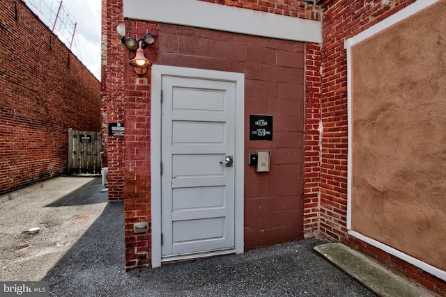 property entrance with brick siding