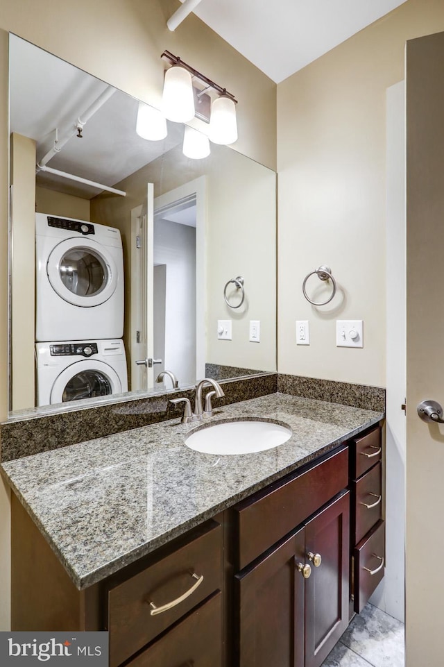 bathroom with stacked washer and dryer and vanity