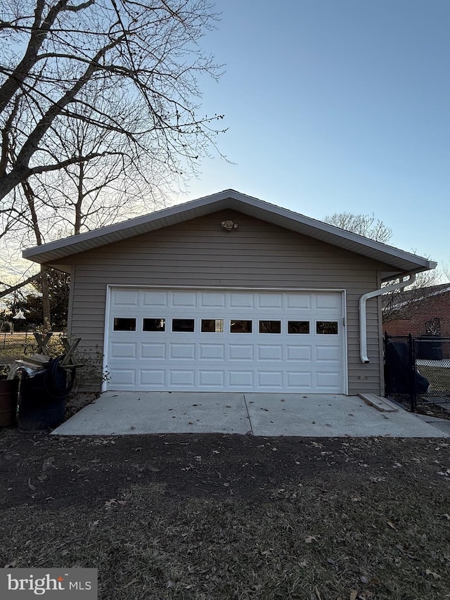 detached garage featuring fence