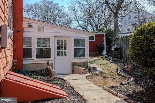 view of exterior entry featuring fence