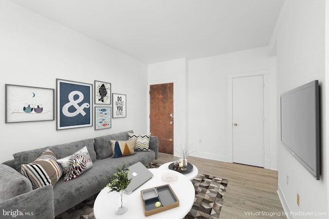 living room featuring baseboards and wood finished floors