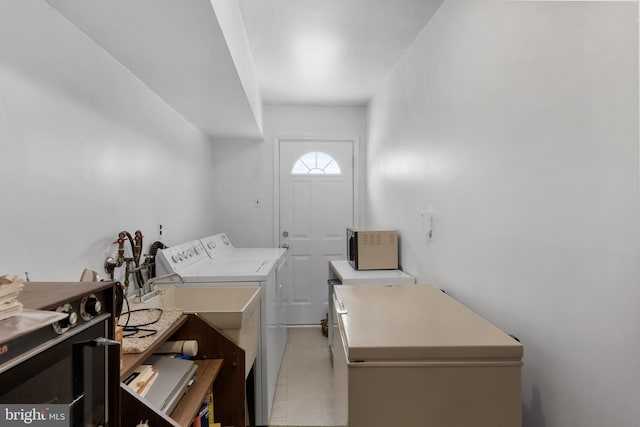 clothes washing area with laundry area and washer and clothes dryer