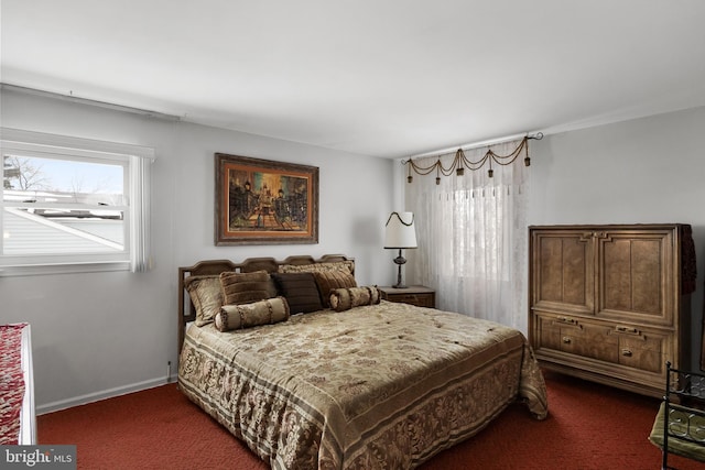 bedroom featuring multiple windows, dark carpet, and baseboards