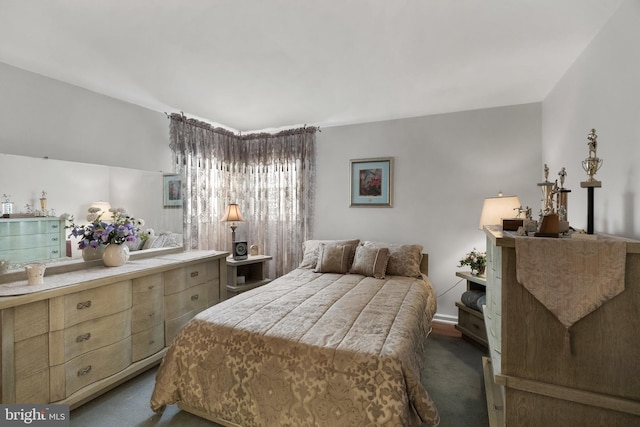 bedroom with dark colored carpet