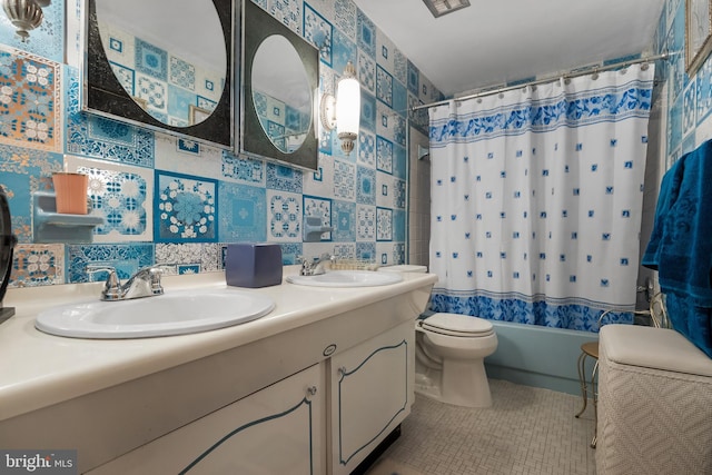 bathroom featuring double vanity, shower / tub combo, tile patterned flooring, and a sink