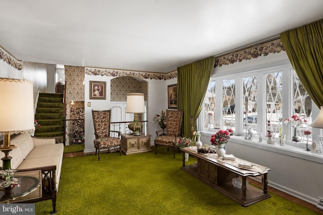 sitting room with baseboards, carpet floors, stairway, and wallpapered walls