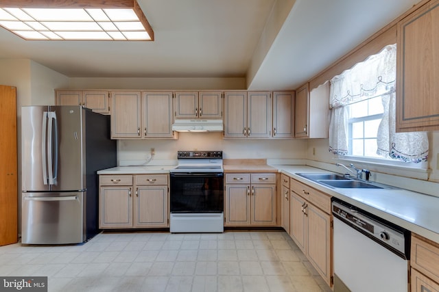 kitchen featuring freestanding refrigerator, white dishwasher, a sink, range with electric cooktop, and under cabinet range hood