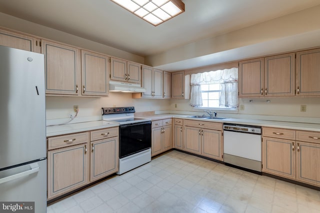 kitchen featuring electric range, dishwasher, freestanding refrigerator, under cabinet range hood, and a sink