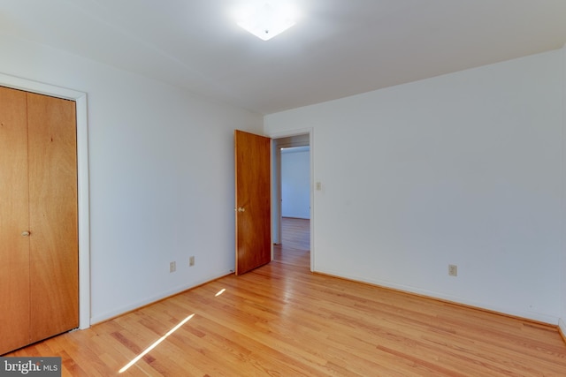 unfurnished bedroom featuring baseboards and wood finished floors