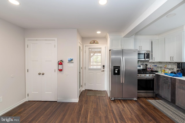 kitchen with dark wood-style floors, appliances with stainless steel finishes, and white cabinets