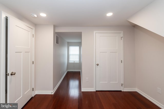 bonus room featuring dark wood-type flooring, recessed lighting, visible vents, and baseboards