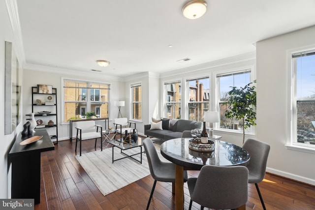 dining area featuring visible vents, baseboards, dark wood-style floors, and crown molding