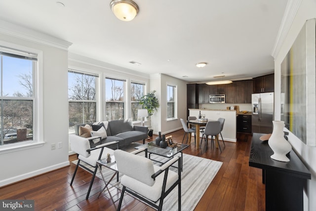 living area featuring visible vents, baseboards, ornamental molding, and dark wood-style flooring