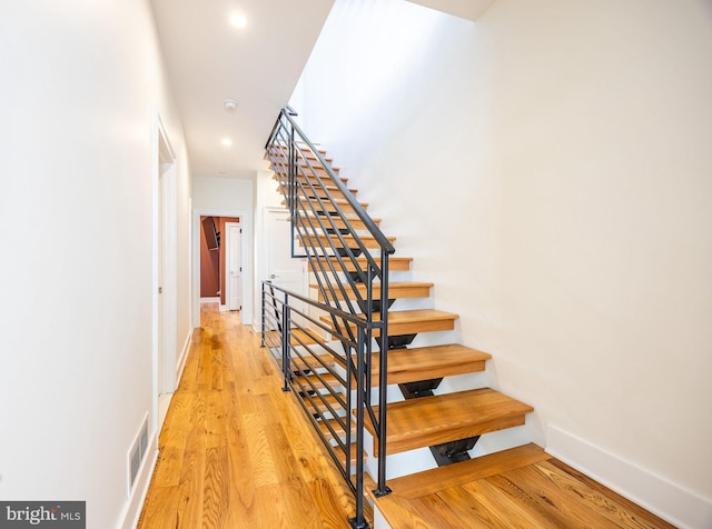 stairs featuring recessed lighting, wood finished floors, visible vents, and baseboards