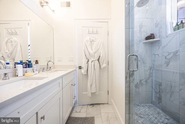 full bath with marble finish floor, double vanity, visible vents, a sink, and a shower stall