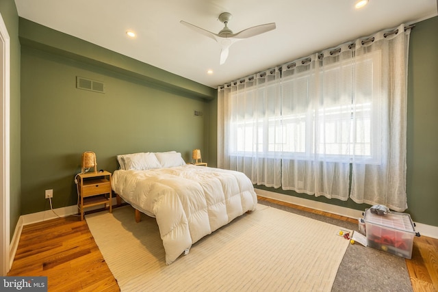 bedroom featuring recessed lighting, wood finished floors, a ceiling fan, visible vents, and baseboards