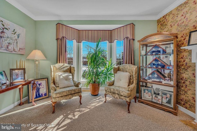 sitting room with carpet flooring, crown molding, baseboards, and wallpapered walls