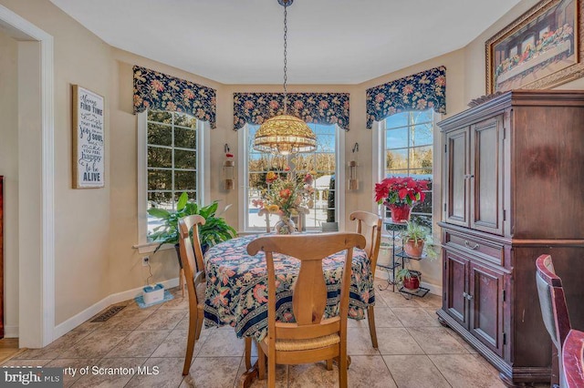 dining room with light tile patterned flooring, visible vents, and baseboards