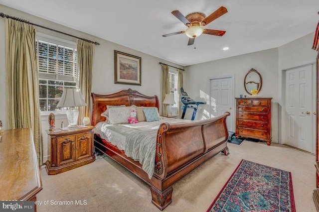 bedroom with light carpet, a ceiling fan, and recessed lighting