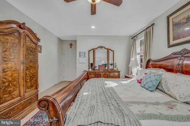 bedroom with a ceiling fan and baseboards