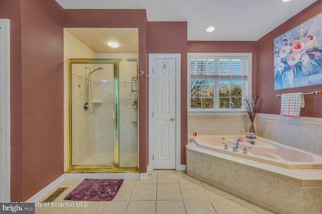 full bathroom with tile patterned flooring, visible vents, baseboards, a shower stall, and a bath