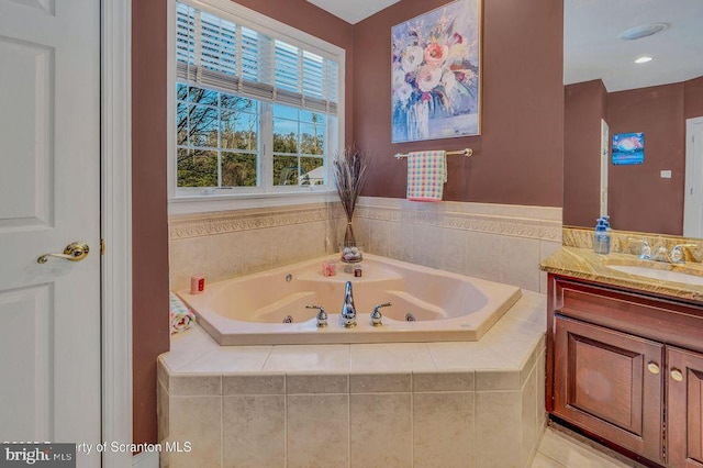 full bath with a whirlpool tub and vanity