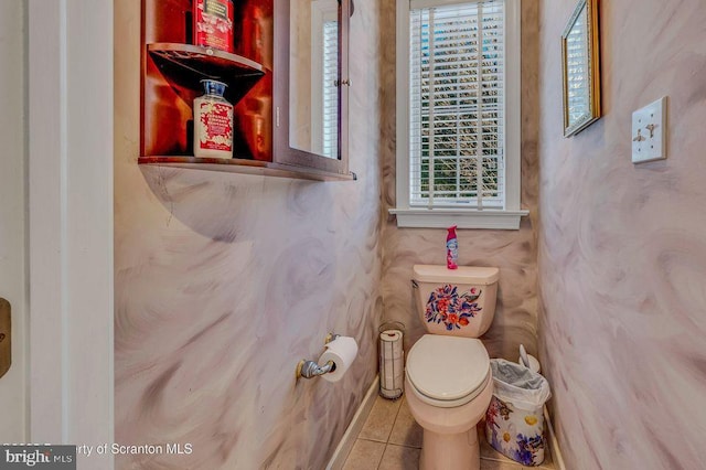 half bath featuring toilet and tile patterned floors