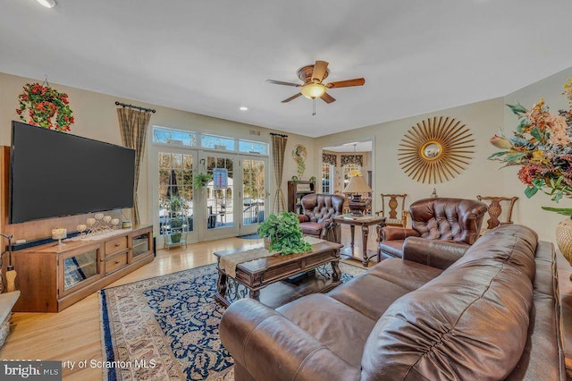 living area with light wood finished floors and ceiling fan