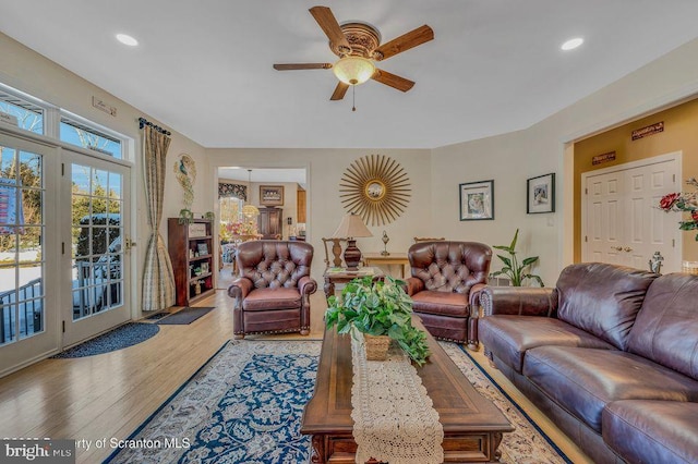 living area with ceiling fan, wood finished floors, and recessed lighting