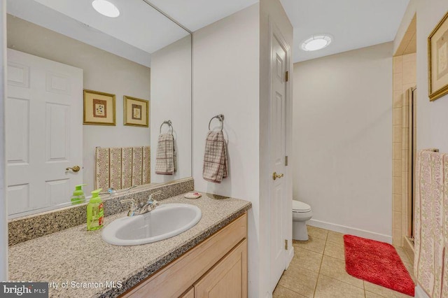 full bath featuring tile patterned flooring, toilet, vanity, baseboards, and an enclosed shower