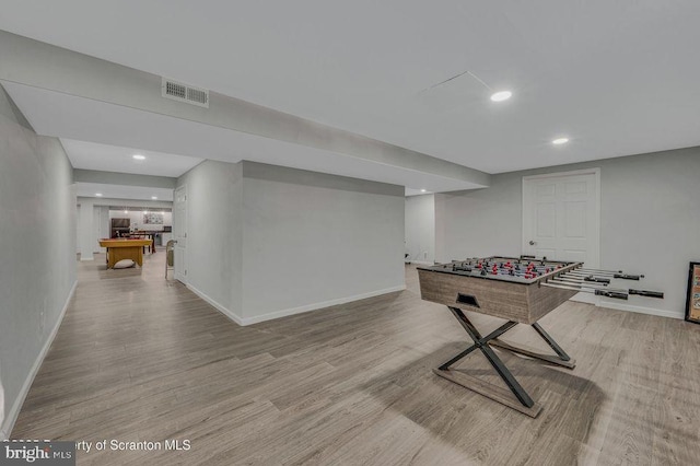 game room featuring light wood-type flooring, baseboards, and visible vents