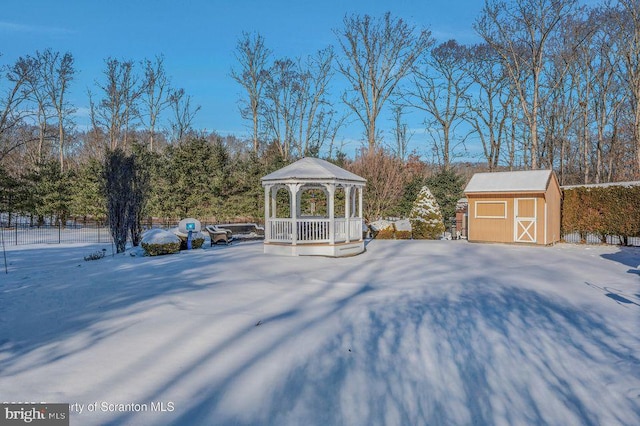 view of yard featuring a storage shed, fence, an outbuilding, and a gazebo