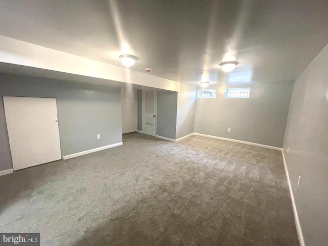 basement featuring carpet floors and baseboards