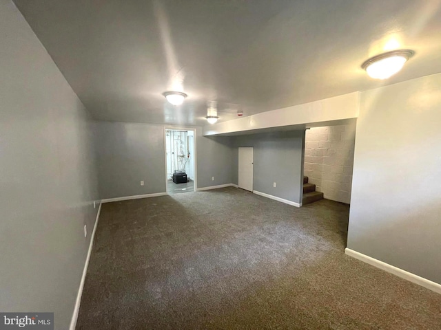 interior space featuring stairway, dark carpet, and baseboards