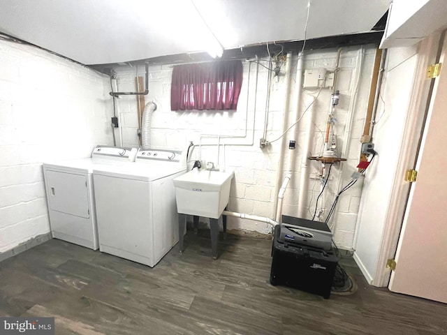 laundry room with a sink, laundry area, dark wood-style flooring, and washing machine and dryer