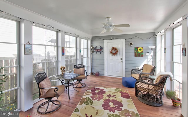 sunroom with a ceiling fan