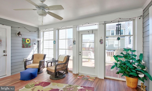 sunroom / solarium featuring ceiling fan