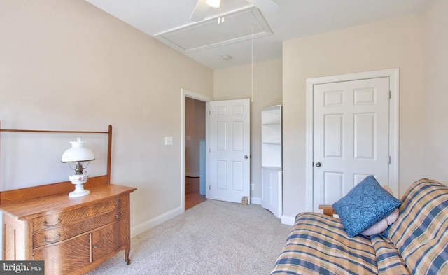 living area featuring attic access, baseboards, and carpet floors