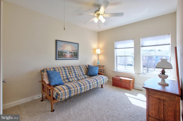 living room featuring baseboards, a ceiling fan, and carpet flooring